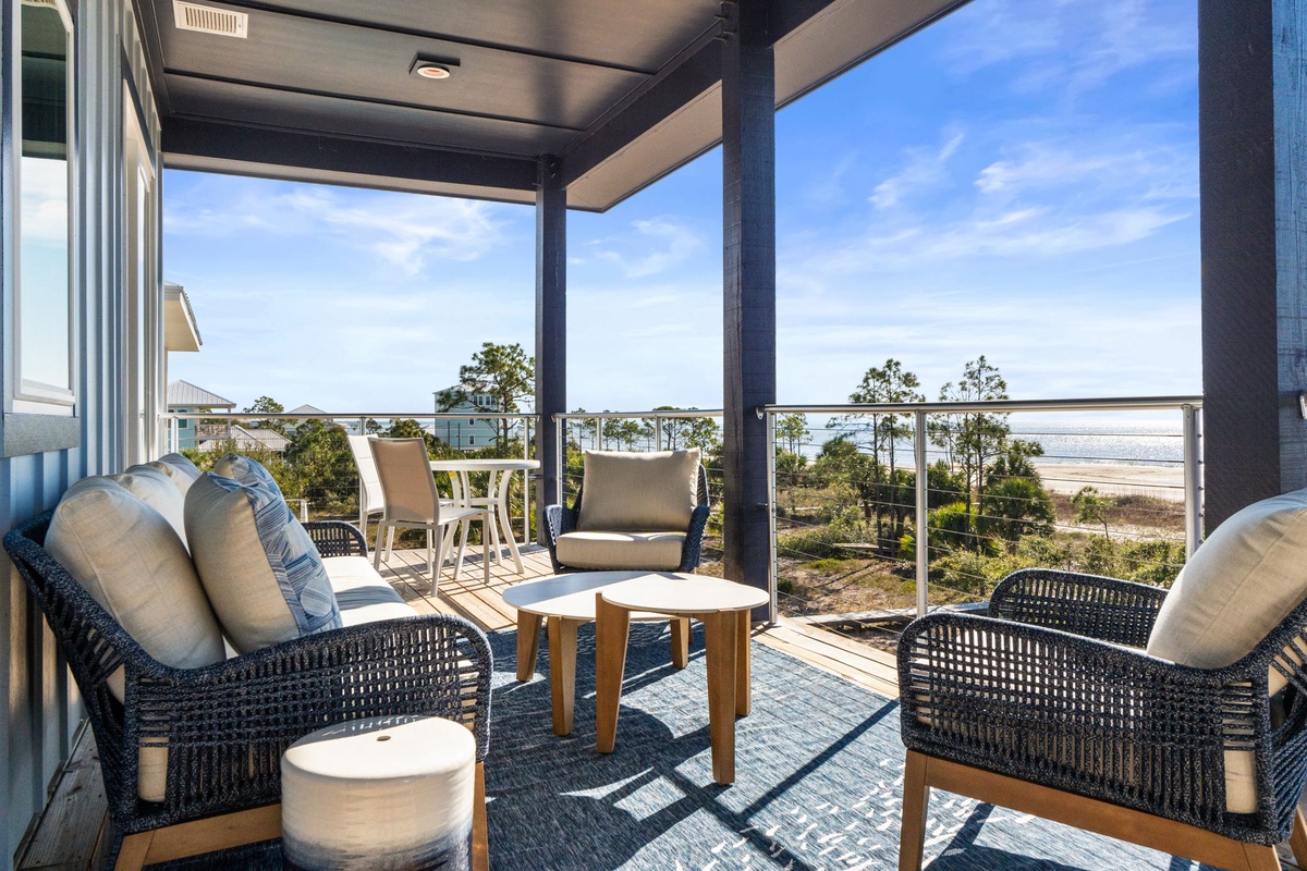 Relax in comfort on your private covered terrace with stunning ocean views and plush seating.