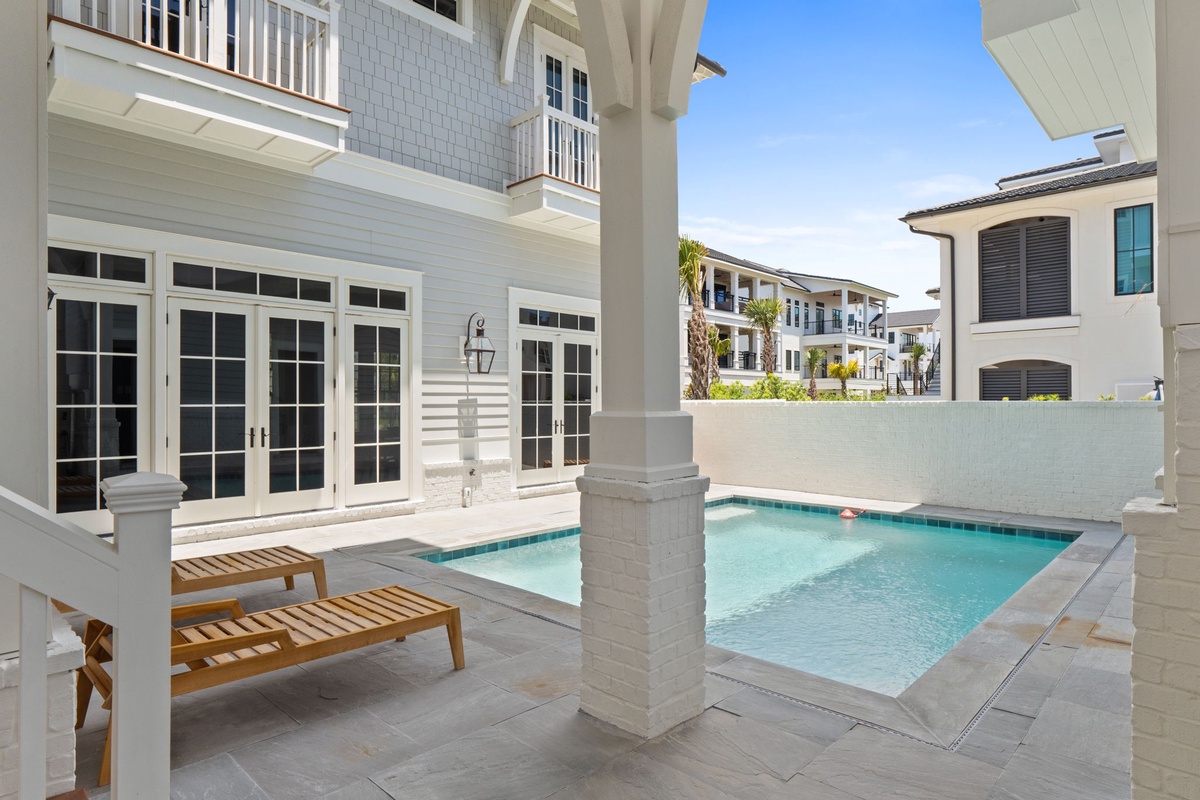 A private oasis awaits with your very own plunge pool, complemented by coastal architecture and elegant French doors that open to a serene, sun-drenched courtyard perfect for relaxation.