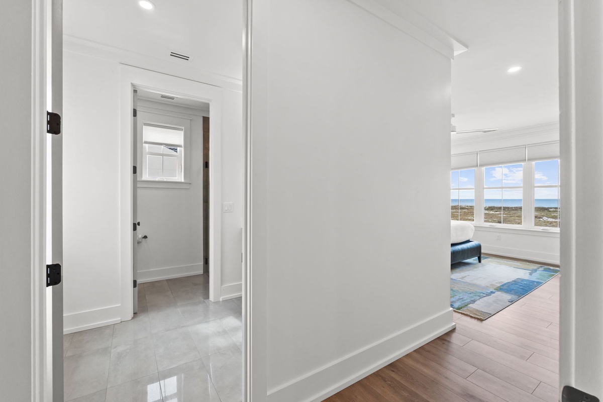 Step into your bright, modern hallway with gleaming floors and natural light flowing throughout your spacious retreat.