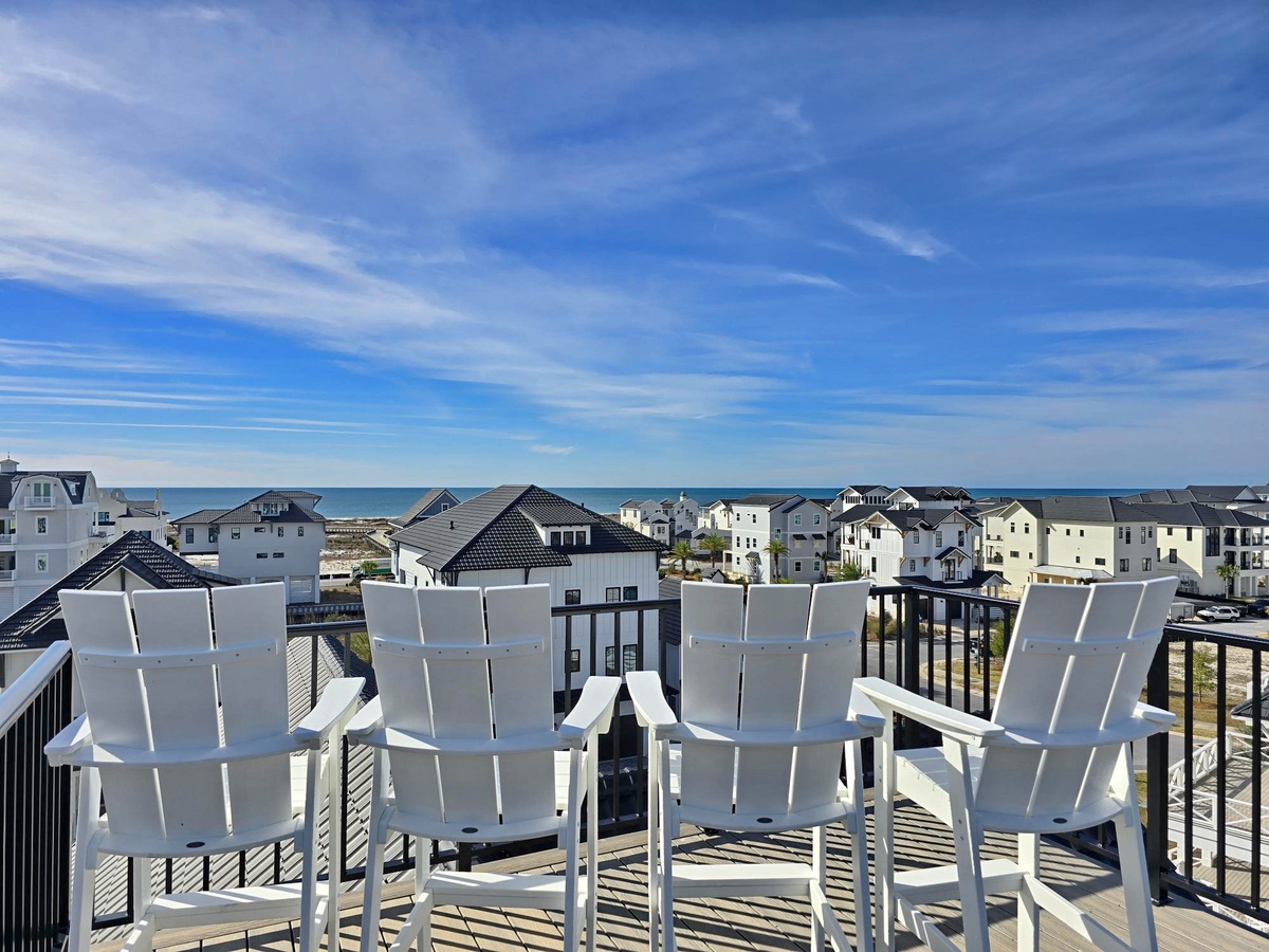 Soak up the coastal breeze from your private balcony with panoramic views of charming beach homes stretching toward the horizon.