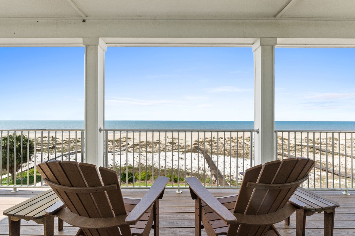 Imagine sipping your morning coffee here, with endless ocean views stretching before you. Your private screened-in porch opens directly to sandy shores and turquoise waves—pure beachfront bliss awaits.