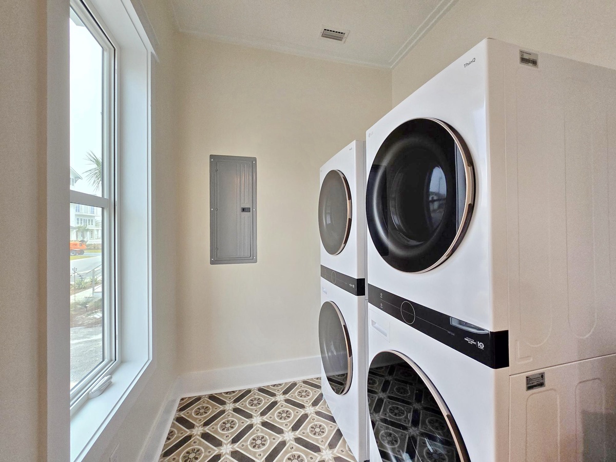 Your dedicated laundry space features stacked premium appliances with plenty of natural light for easy sorting and folding.