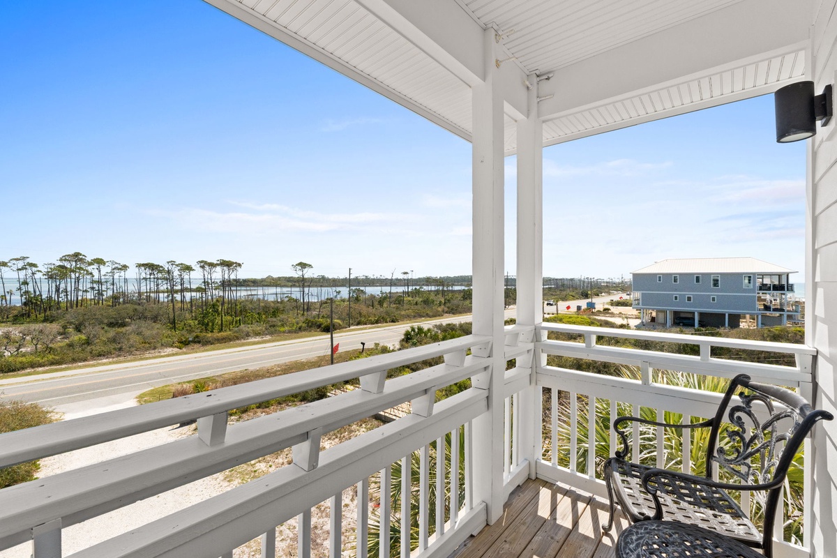 Relax on your covered balcony with sweeping coastal views, where morning coffee feels like a peaceful retreat.