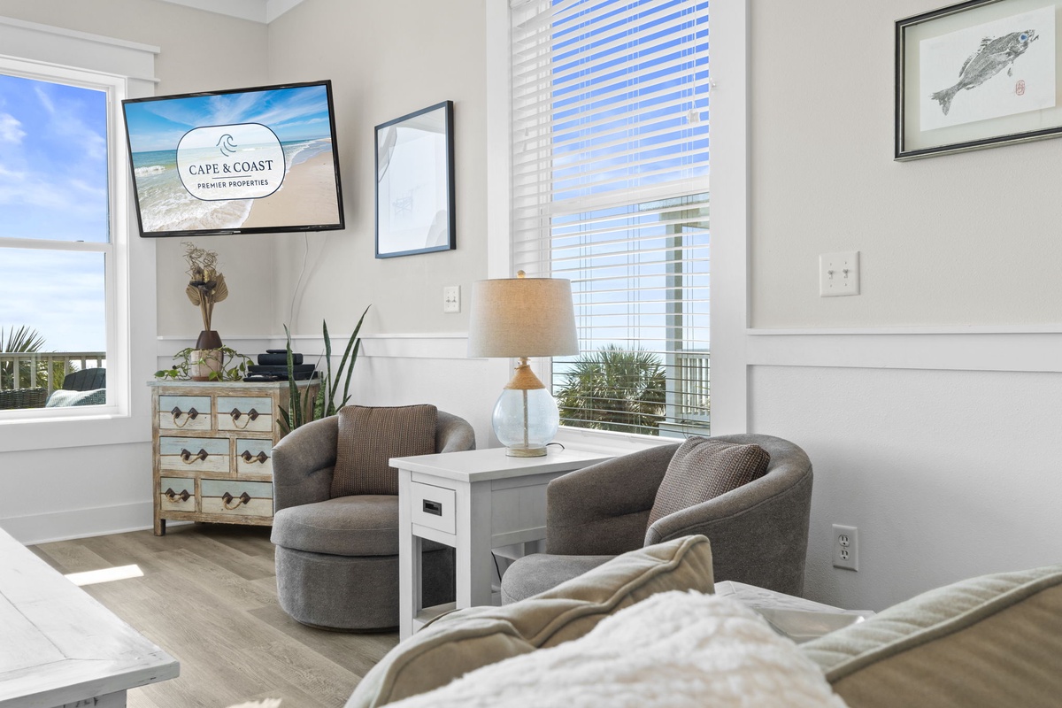 Unwind in your bright coastal living room with comfortable seating, ocean-inspired decor, and natural light streaming through.