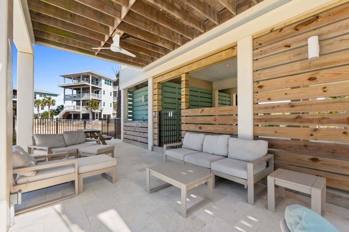 Unwind in your private covered patio with comfortable seating and cool ocean breezes while enjoying views of nearby beachfront properties.
