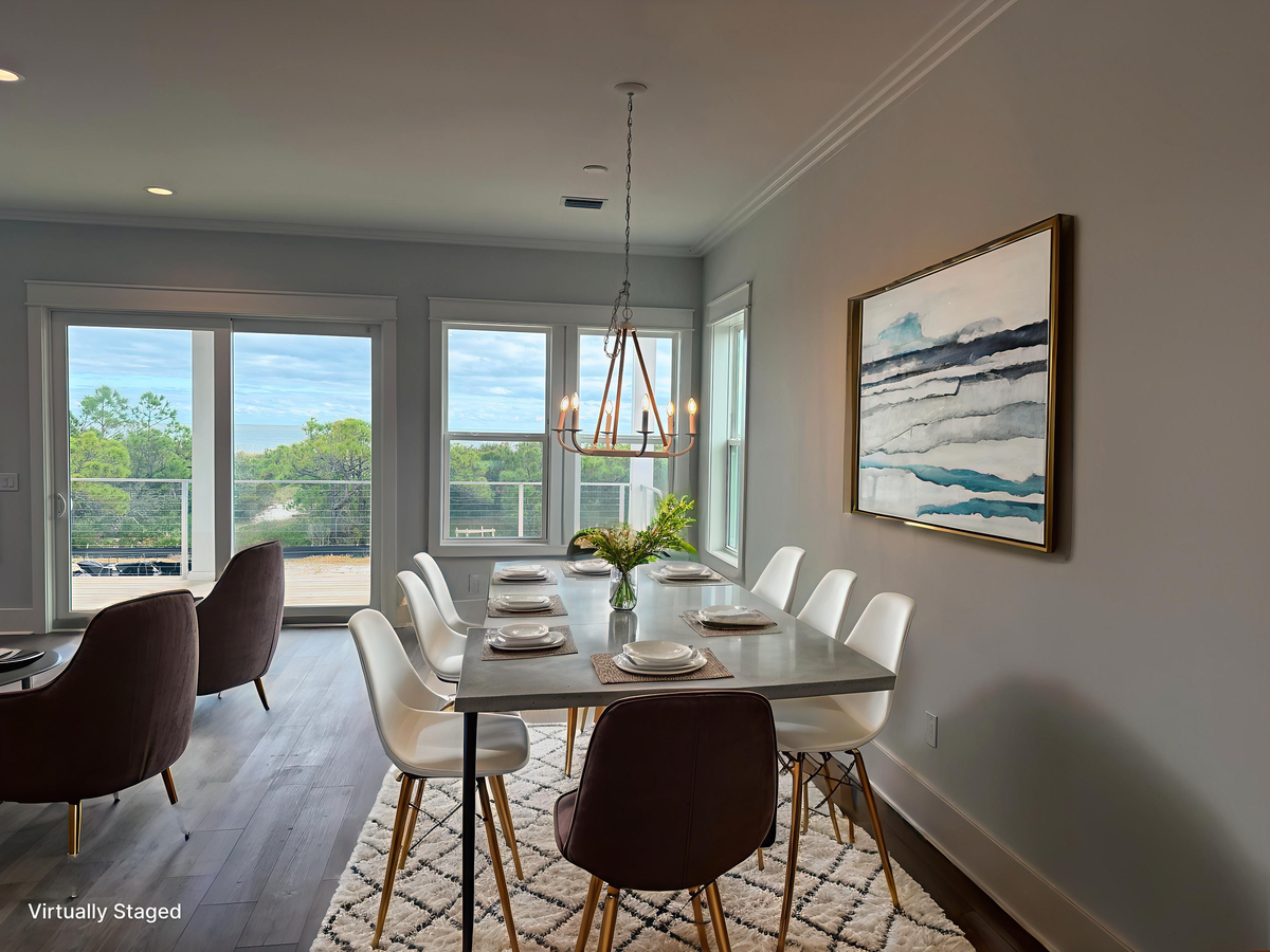 Gather around this stylish dining table where your group can share meals while enjoying natural light streaming through expansive windows.