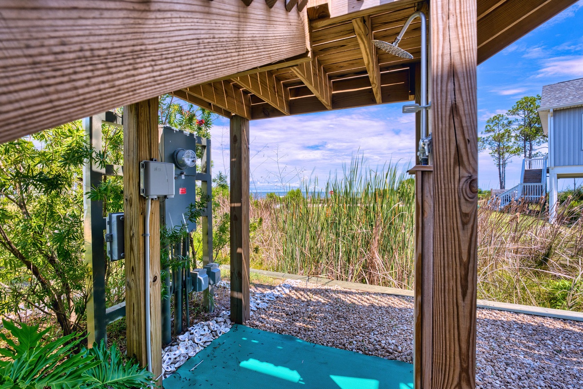 Rinse off the sand and salt under your private outdoor shower, surrounded by coastal grasses and ocean breezes—a refreshing end to your beach days.