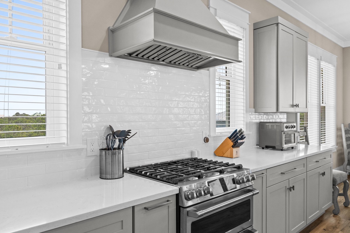Your gourmet kitchen awaits with a professional gas range, gleaming countertops, and all the tools you need to whip up memorable meals during your stay.