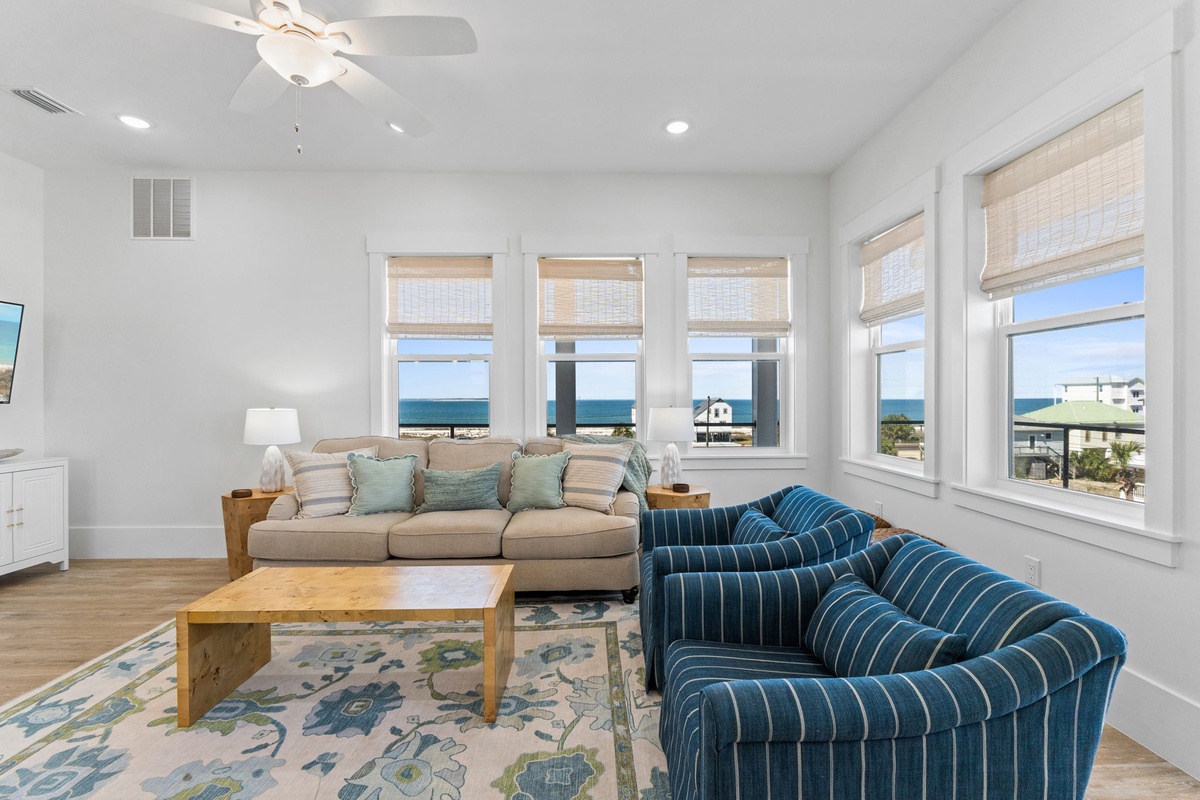 Unwind in your bright coastal living space with ocean views, comfy seating, and seaside breezes flowing through.