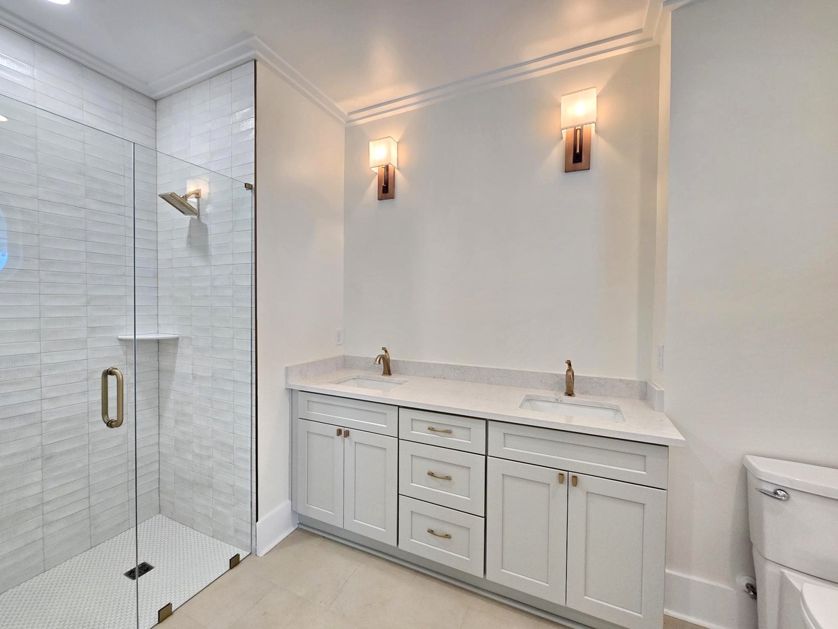Unwind in your elegant ensuite with a spacious glass shower and double vanity, perfectly lit for your morning routine.