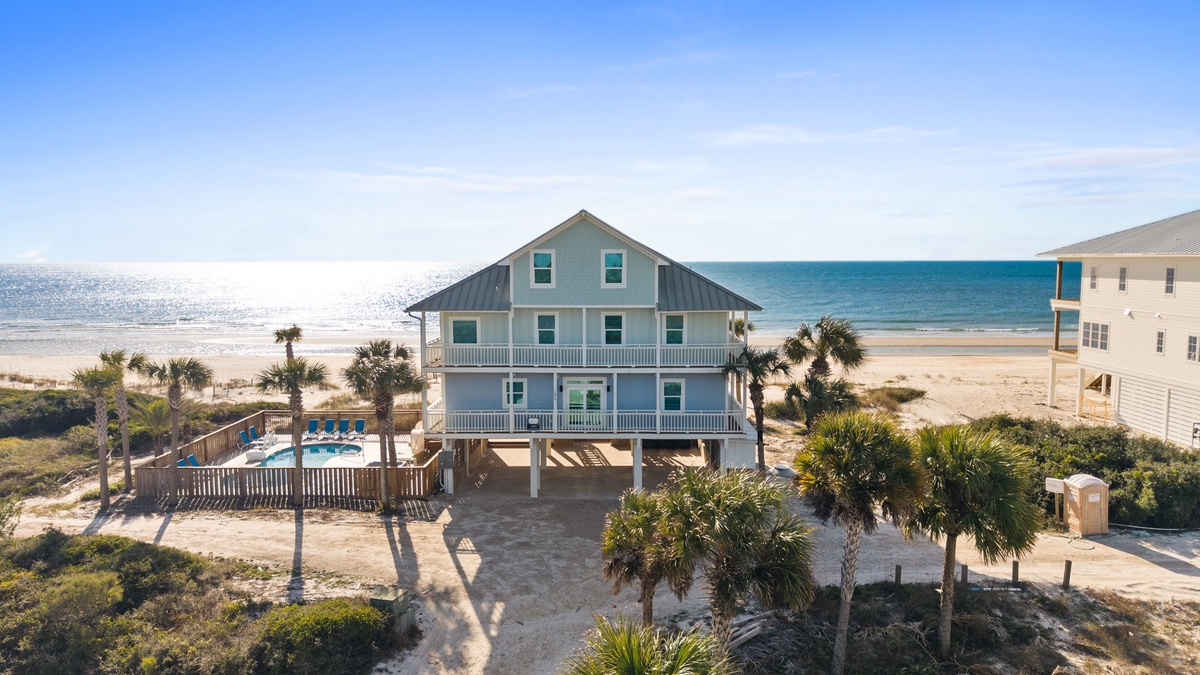 Beachfront paradise with pristine sandy shores and sparkling ocean waters just steps from the property.