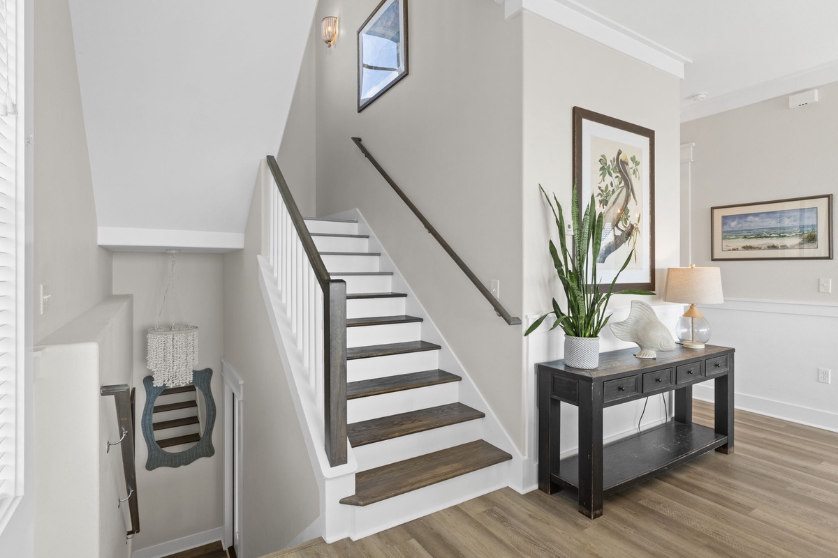 Step into your welcoming entrance where warm wood floors and elegant furnishings create an inviting first impression for your stay.