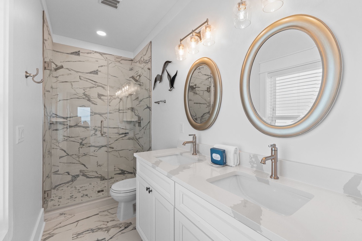 Step into your sleek, spa-like bathroom with elegant marble finishes, dual vanities, and a refreshing walk-in shower—designed to make mornings feel effortless and evenings relaxing.