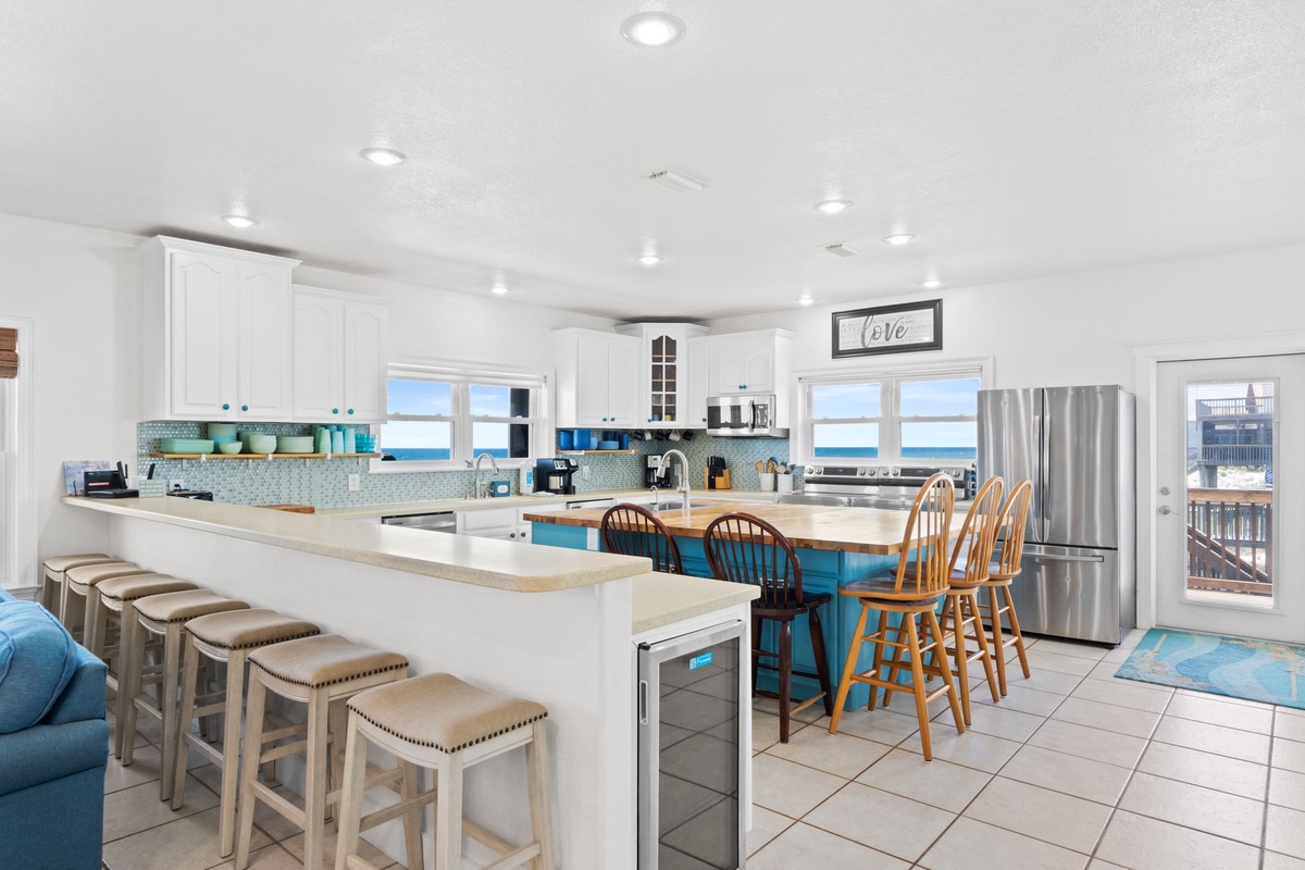 Your dream beach escape starts here—a bright, fully equipped kitchen with ocean views through every window. Gather around the spacious island for morning coffee or prepare meals while soaking in the coastal vibes.