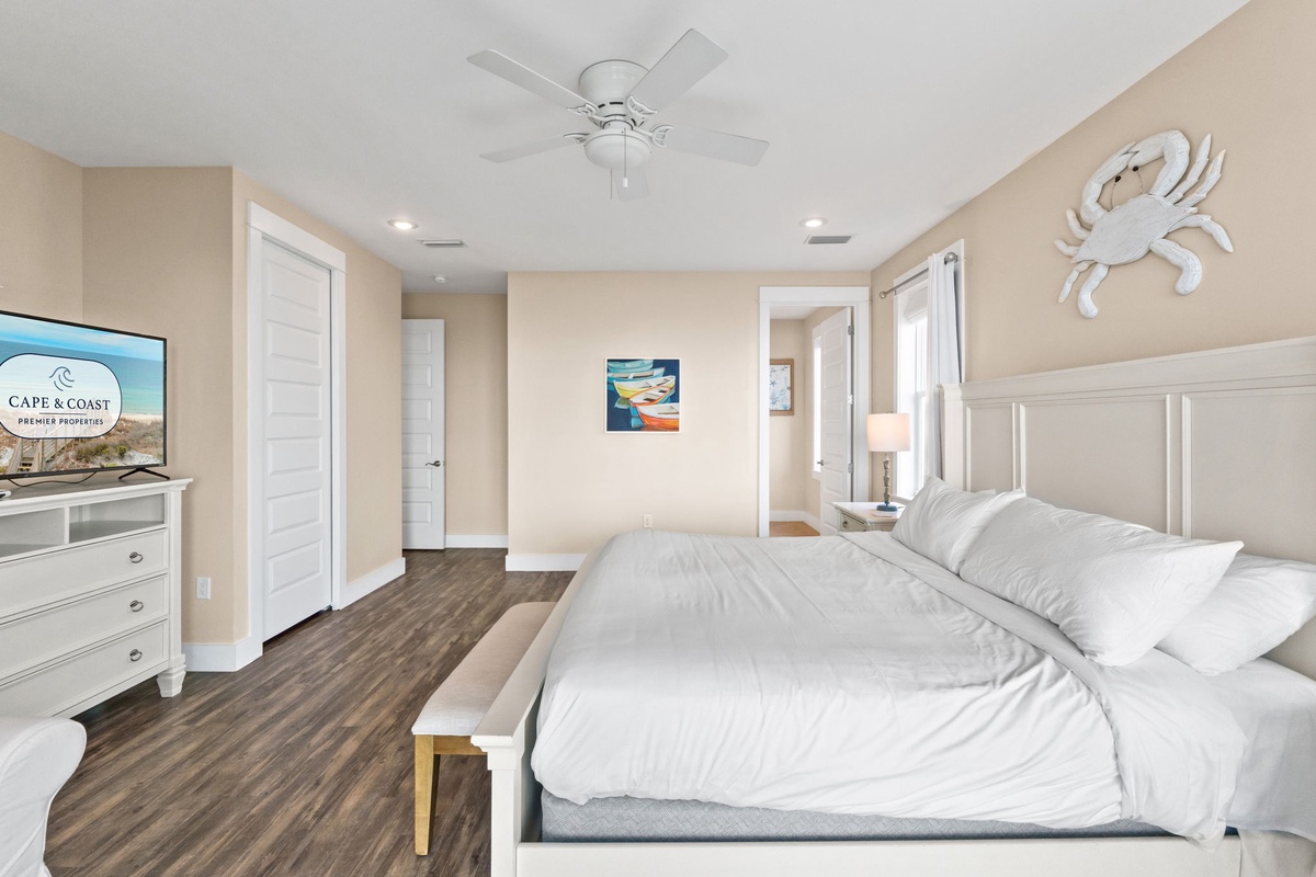 Drift off in your serene coastal bedroom, where white linens and nautical charm create the perfect retreat after beach days.