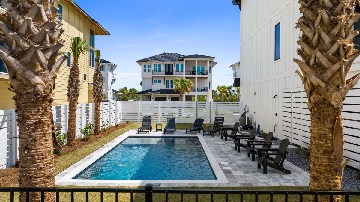 Your private pool oasis awaits, framed by swaying palms and stylish loungers—perfect for soaking up the sun or enjoying sunset swims in your own secluded escape.
