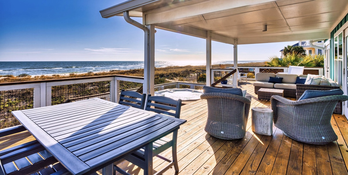 Relax on your private oceanfront deck with stunning sea views, comfortable seating, and dining space for unforgettable coastal evenings.
