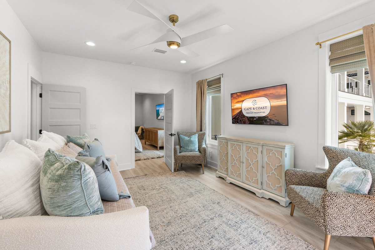 Sink into plush seating while enjoying your favorite shows on the large TV in this stylish living space.