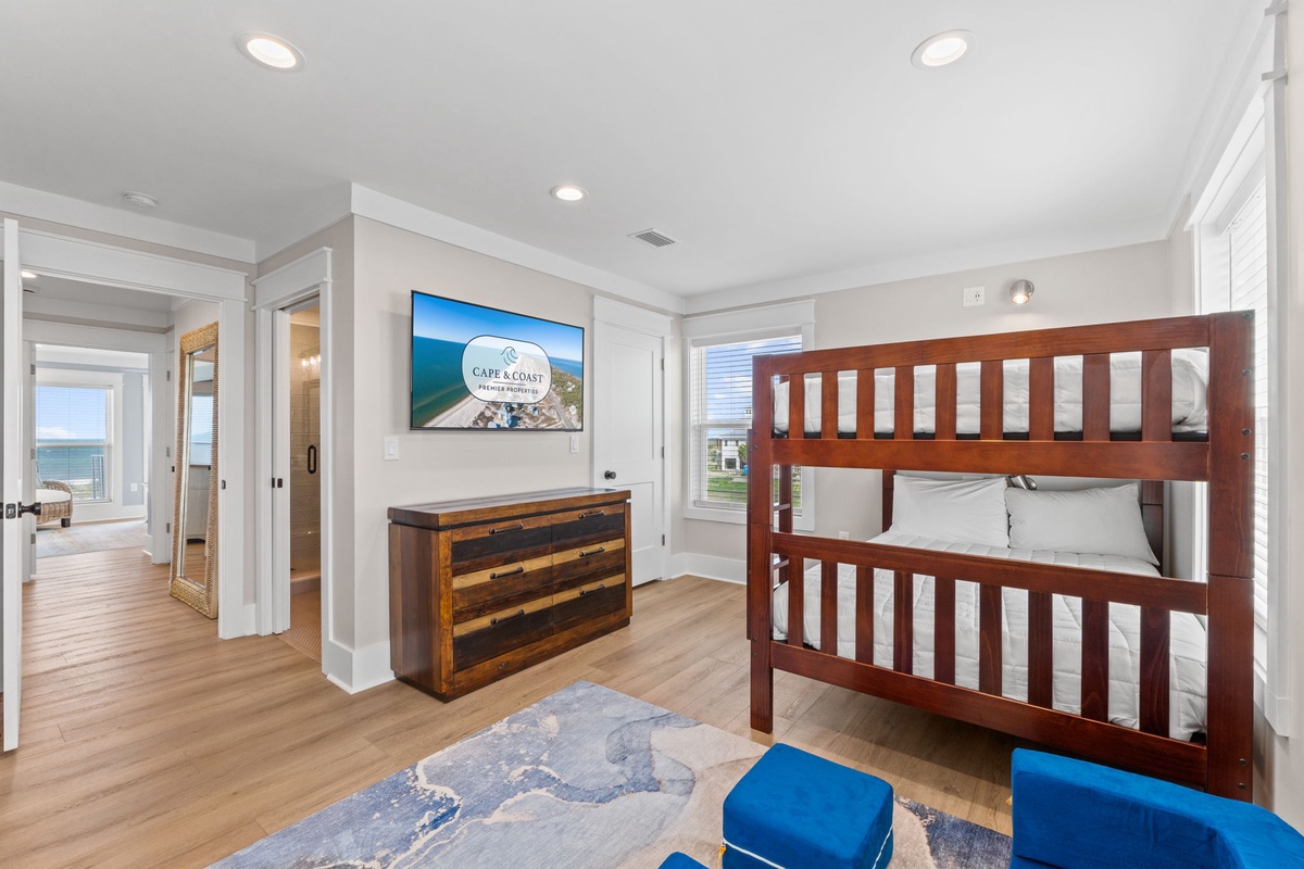 A cozy bunk room awaits your crew, complete with ocean views through the window and coastal charm throughout. Settle in and let the waves outside lull everyone to sleep after a sun-soaked day.