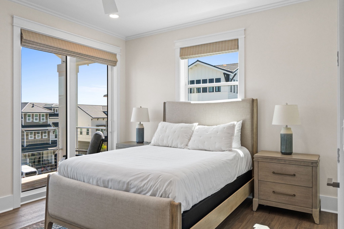 Wake up refreshed in your sunlit bedroom, where soft coastal breezes and neighborhood views greet you each morning through elegant windows.