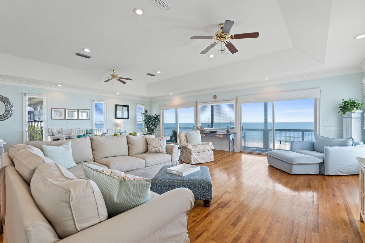 Sink into plush sofas while ocean waves dance outside your floor-to-ceiling windows in this airy coastal retreat.