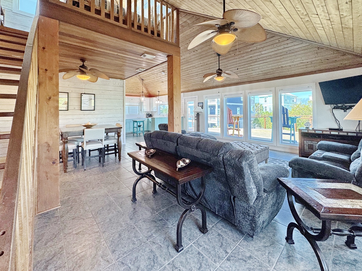 Relax in your open-concept living space with soaring ceilings, cozy seating, and bright windows overlooking the neighborhood.