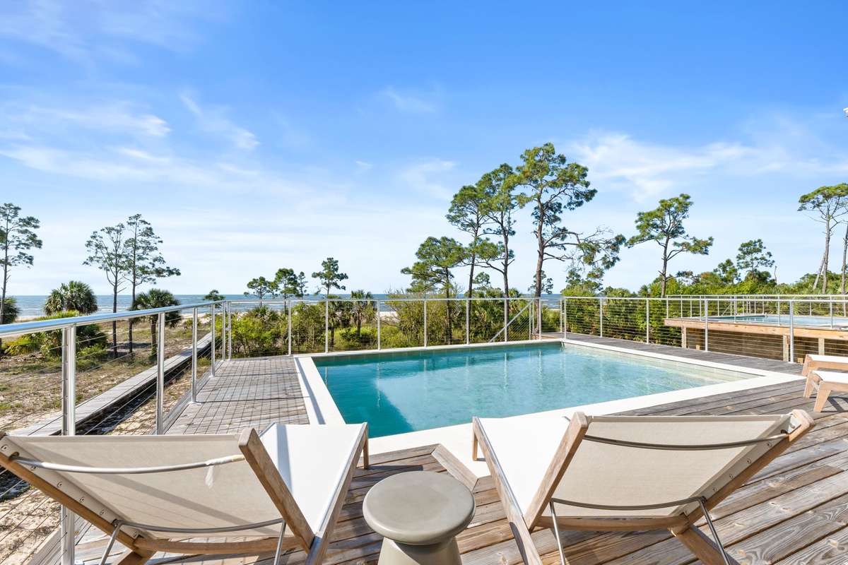 Soak up sunshine by your private pool deck with stunning coastal views stretching to the horizon.