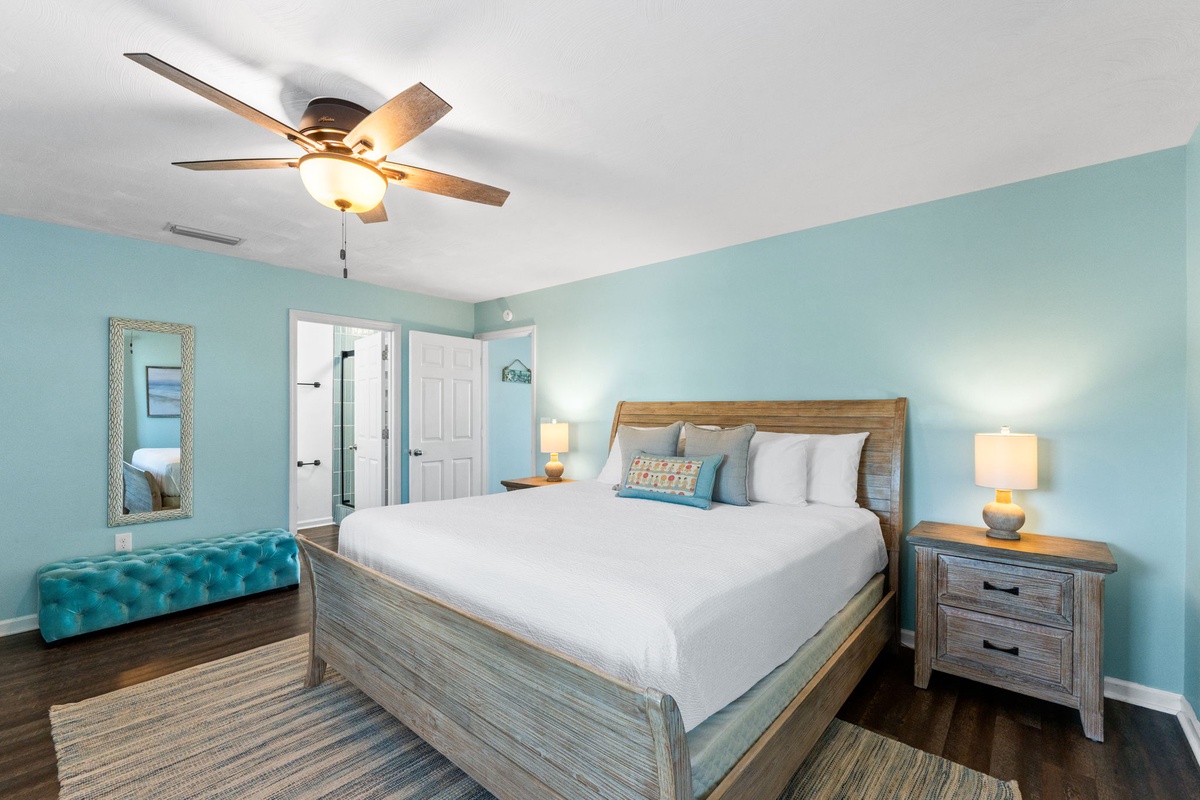 Drift off in your tranquil coastal bedroom, where soothing aqua walls and weathered wood create the perfect seaside retreat.