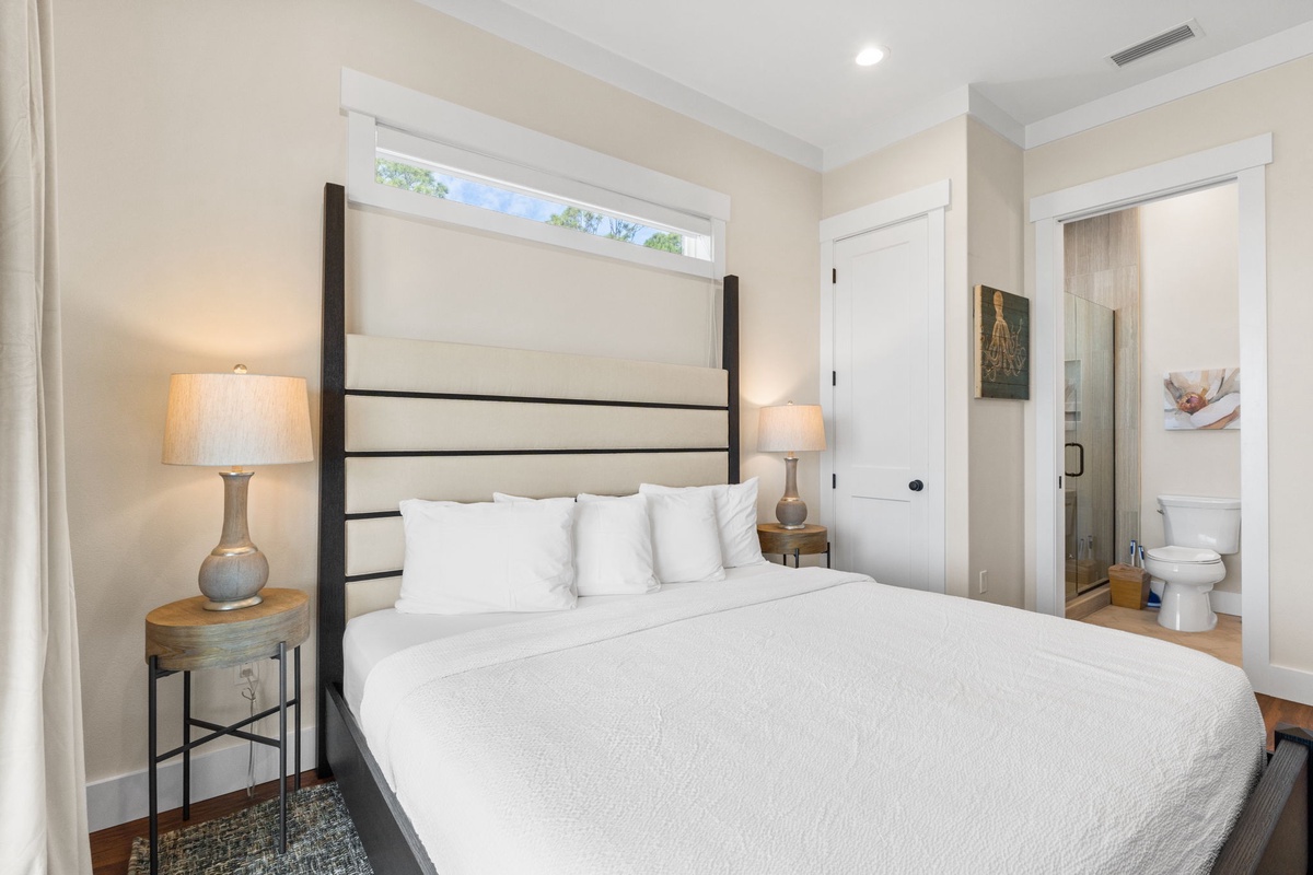 Sink into crisp white linens and let the soft bedside lighting create your perfect retreat for restful nights.