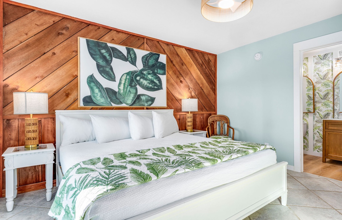 Drift into peaceful slumber in your tropical-themed bedroom, where warm wood accents and soothing mint walls create the perfect sanctuary for rest.