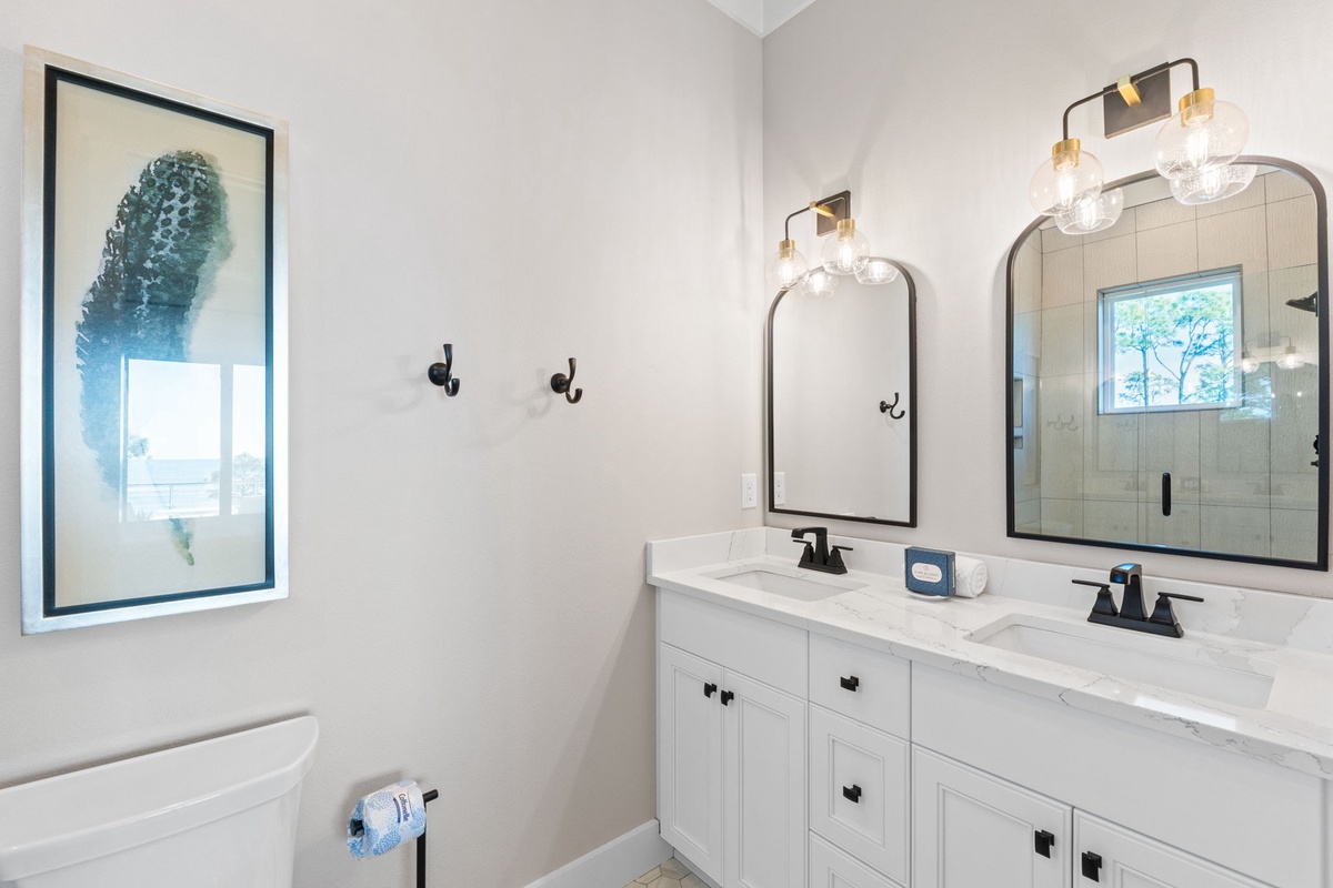 Your stylish double vanity bathroom features marble countertops, modern lighting, and a spacious walk-in shower for refreshing mornings.