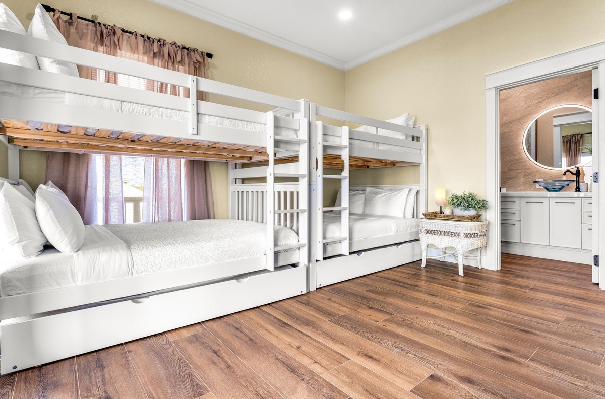 Your family will love this bright bunk room with crisp white linens and plenty of space to relax after adventure-filled days.