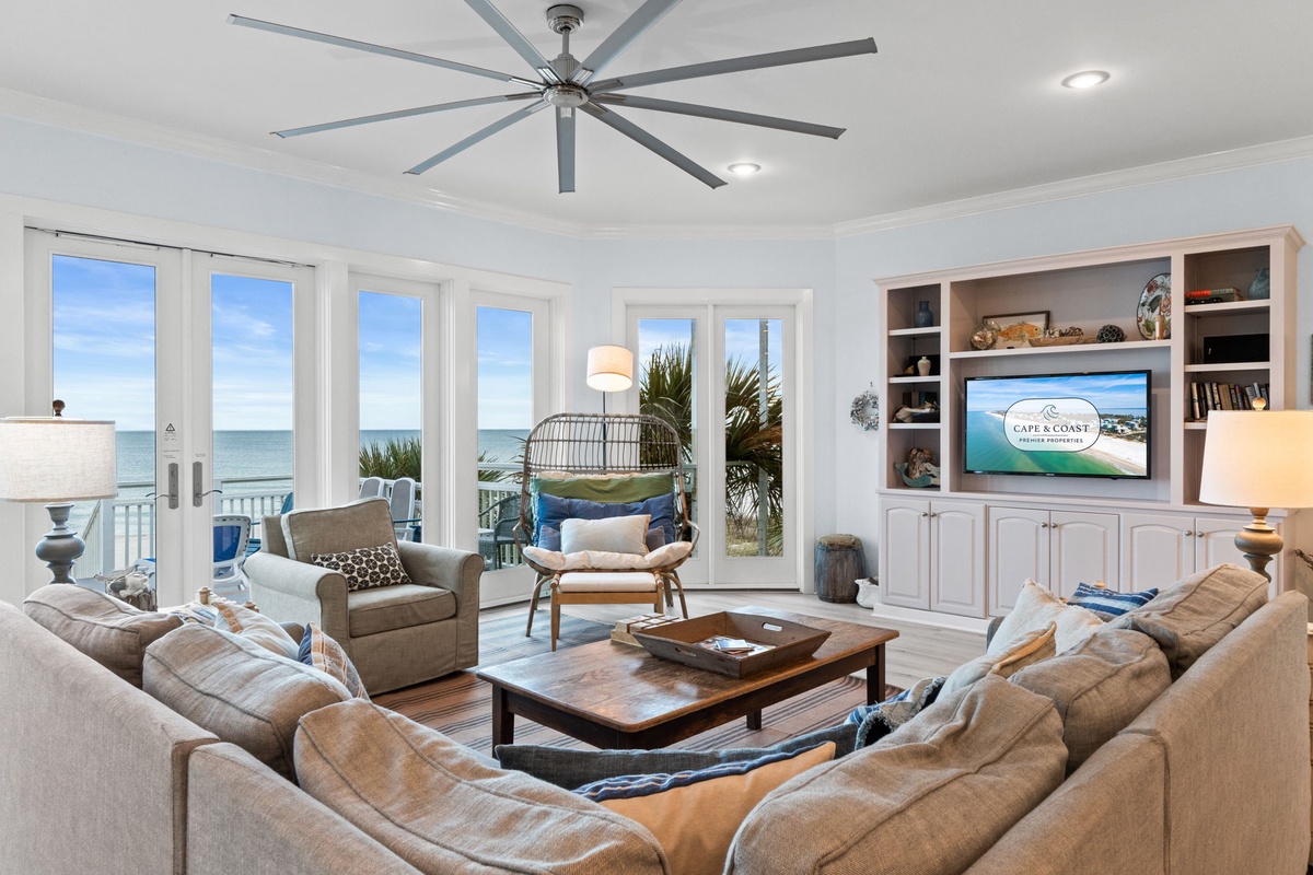 Sink into plush sofas while ocean breezes flow through your beachfront living room, where panoramic sea views create the perfect backdrop for relaxation.