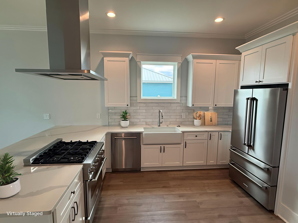 You'll love preparing meals in this bright modern kitchen with stainless appliances, farmhouse sink, and sleek white cabinetry.