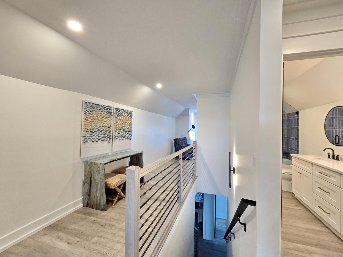 Your upstairs loft features modern railings and stylish nooks, with the master bathroom just steps away for ultimate convenience.