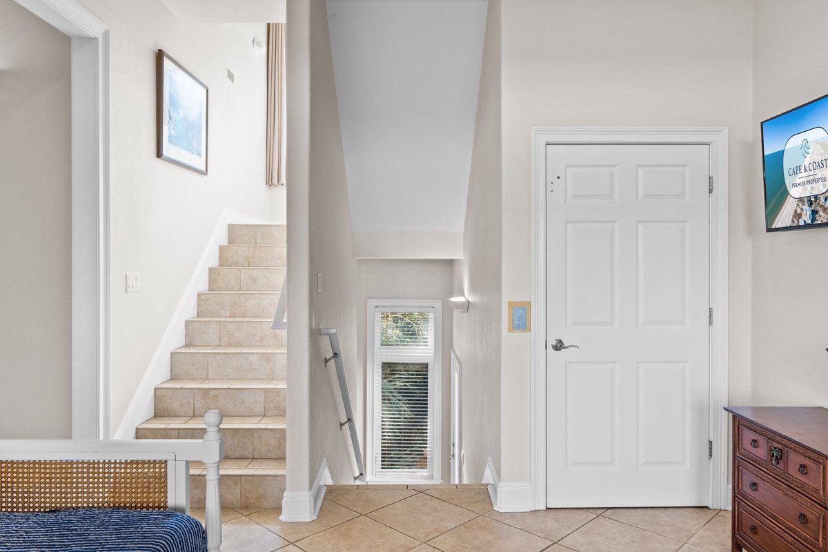 Step into your bright, airy entryway with soaring ceilings and elegant tile floors that welcome you home.