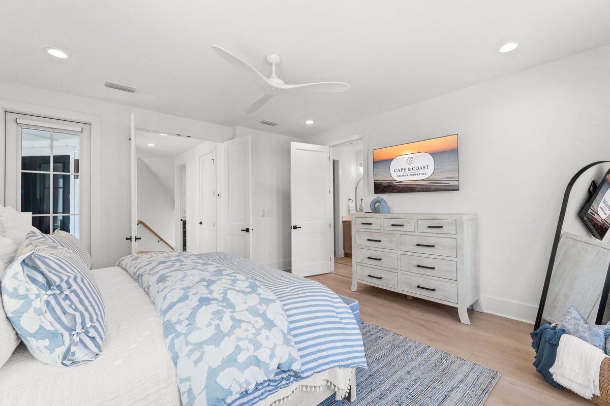 Drift off in this bright, coastal-inspired bedroom with crisp linens and soothing ocean hues creating your perfect seaside retreat.