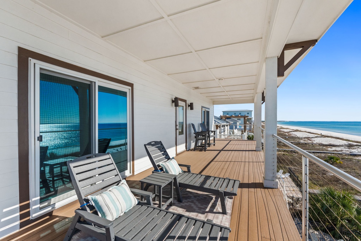 Relax on your private deck with stunning ocean views. Comfortable seating and endless blue horizons create the perfect beachfront retreat.