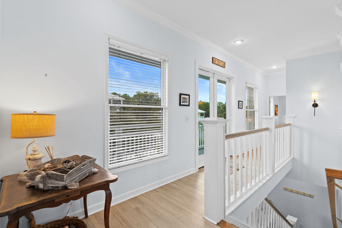 Bright upstairs landing with natural light streaming through windows, offering you a peaceful transition between your private bedrooms.