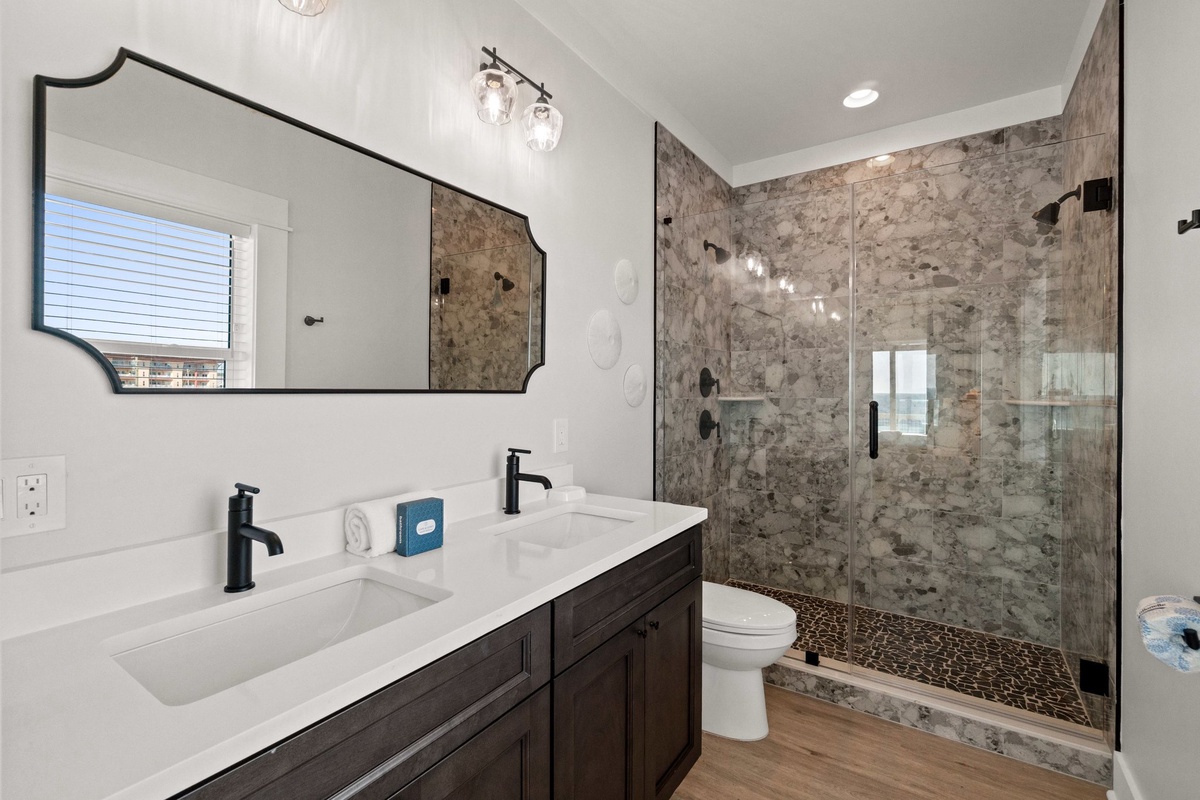 Your private spa-like bathroom features luxurious marble shower, double vanity, and elegant finishes for the perfect relaxation retreat.