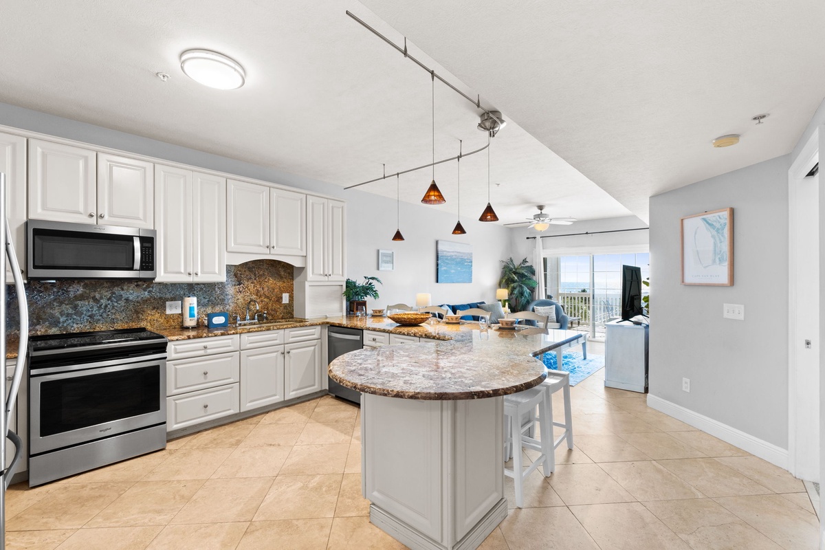Your fully equipped kitchen features granite countertops, stainless steel appliances, and a spacious island perfect for meal prep and casual dining.