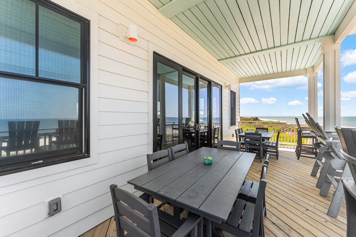 Relax on your expansive oceanfront deck with dining table and lounge chairs, where ocean breezes and endless water views create the perfect outdoor retreat.