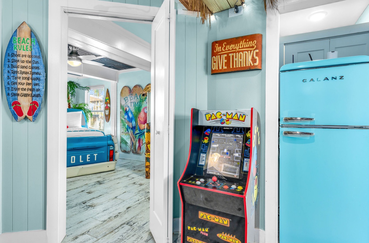 Step into your coastal paradise where beach vibes meet nostalgic gaming fun, complete with vintage arcade entertainment and charming seaside decor.