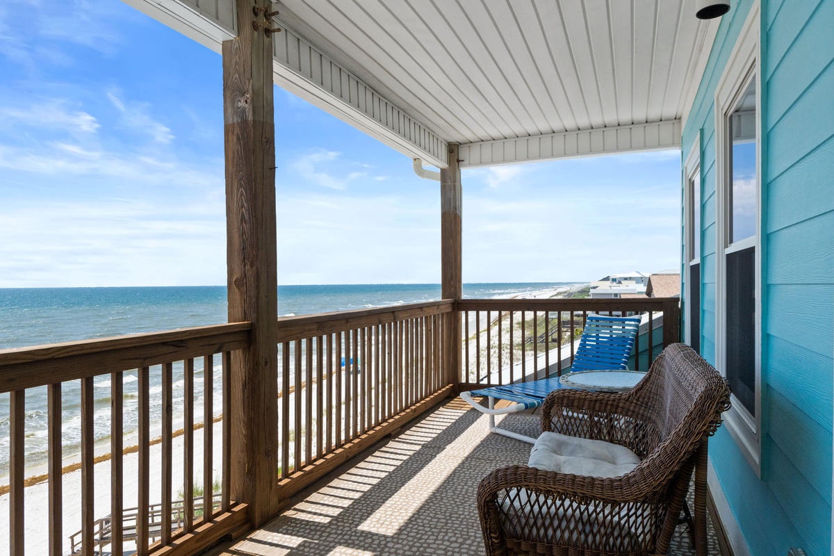 Unwind on your private covered balcony with wicker seating and mesmerizing ocean views, where the sound of waves sets the perfect backdrop for your morning coffee or evening relaxation.