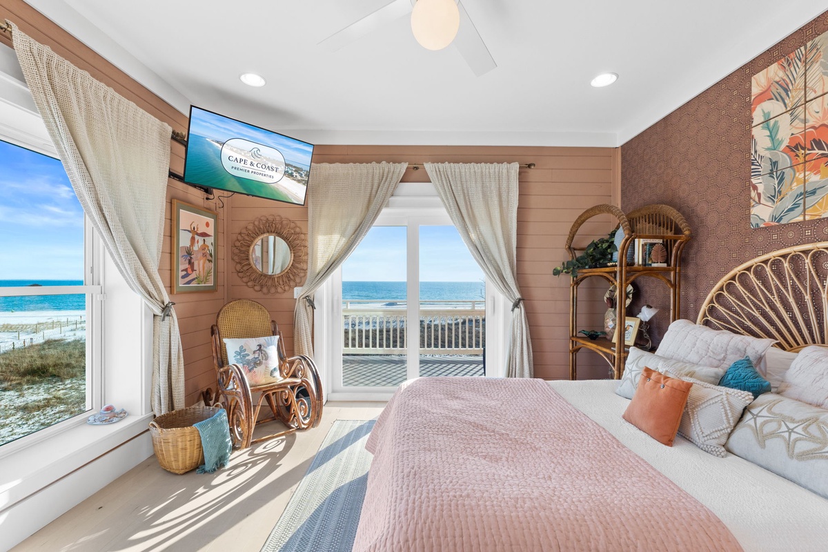 Wake up to stunning ocean views from your coastal bedroom, where rattan furniture and beach-inspired decor create your perfect seaside retreat.