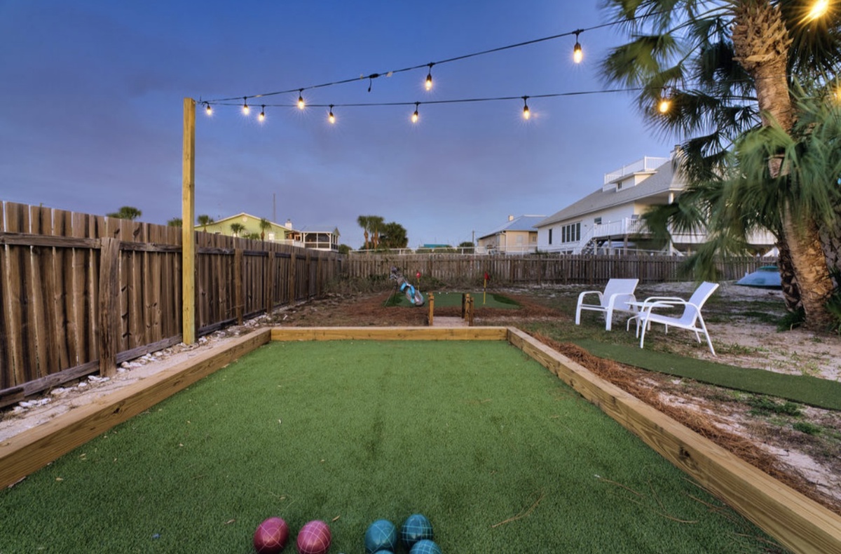 String lighting and open space make the bocce court an inviting spot day or night.