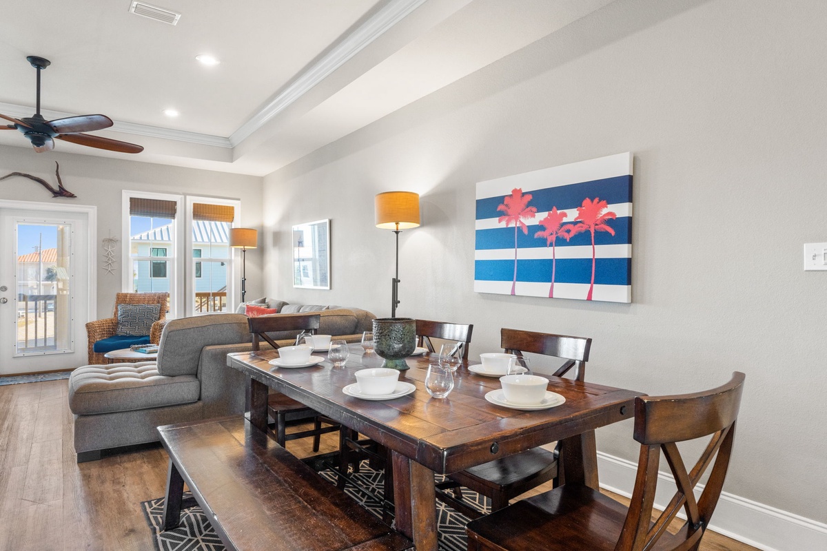 Gather around your dining table set for memorable meals, while the bright living space invites relaxation with coastal artwork and comfortable seating.