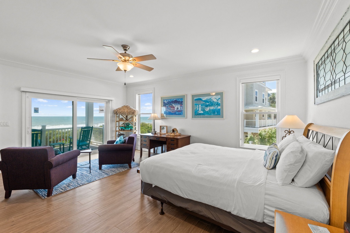 Wake up to the sound of waves in your spacious beachfront bedroom. Sliding glass doors open to sweeping ocean views, while cozy seating invites you to linger with morning coffee.