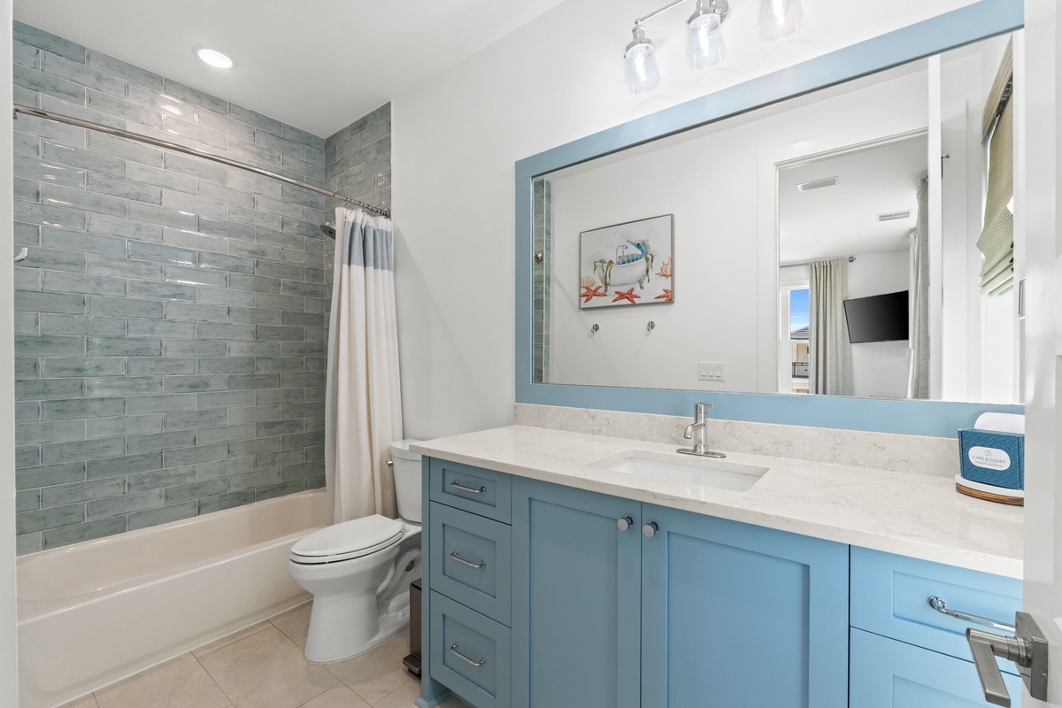 Refresh in your coastal-inspired bathroom with soft blue tones, spa-like tile, and plenty of counter space to spread out your essentials.