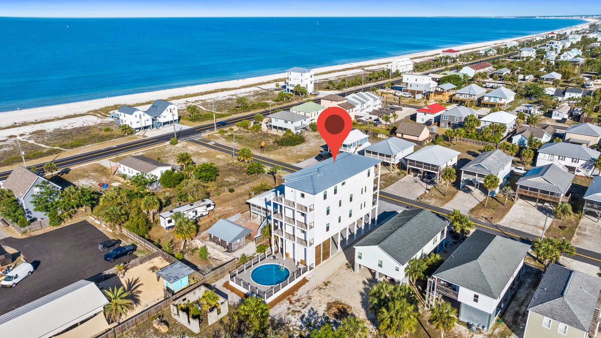 Stunning beachfront location just steps from pristine white sand and turquoise waters in a charming coastal neighborhood.